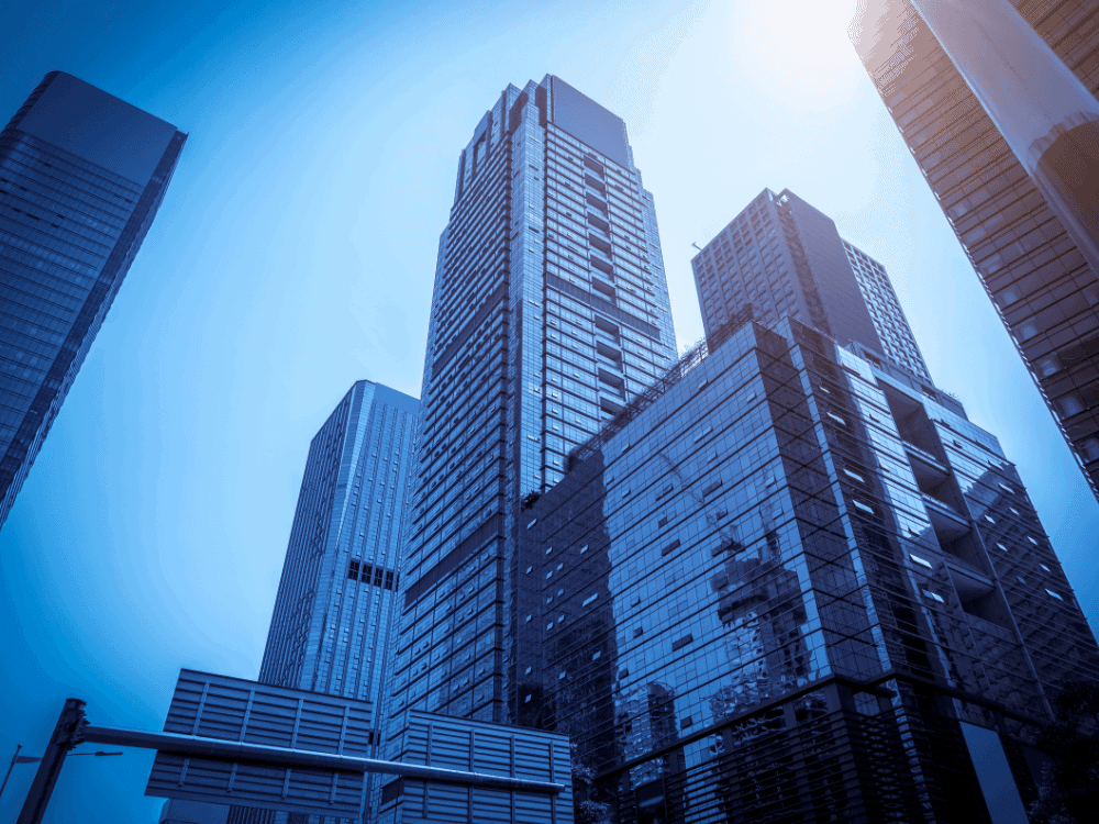Arranha-céus comerciais com fachadas de vidro representam imóveis corporativos que podem ser utilizados em operações de sale leaseback.